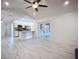 Open-concept living room and kitchen featuring sleek marble tile flooring, backyard views and white cabinets at 1005 Cameo Crest Ln, Valrico, FL 33596