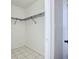 A walk-in closet with rack and tiled floor at 1005 Cameo Crest Ln, Valrico, FL 33596