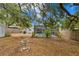 Spacious backyard featuring lush trees, a shed, and a screened-in pool area offers a tranquil outdoor space at 10442 Cirimoya Ln, Seminole, FL 33772