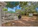 A lush backyard with ample space features a picnic area, grill, and screened-in pool at 10442 Cirimoya Ln, Seminole, FL 33772
