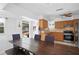 Open kitchen and dining area with view of the pool, wood cabinets and stainless appliances at 10442 Cirimoya Ln, Seminole, FL 33772