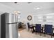 Open-concept kitchen with stainless steel refrigerator and adjacent dining area at 10442 Cirimoya Ln, Seminole, FL 33772