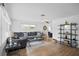 Bright living room with hardwood floors, a large sectional sofa, and modern decor at 10442 Cirimoya Ln, Seminole, FL 33772
