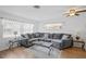 Spacious living room with a plush sectional sofa and stylish furnishings at 10442 Cirimoya Ln, Seminole, FL 33772