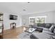 Comfortable living room with ample seating and natural light from a large window at 10442 Cirimoya Ln, Seminole, FL 33772