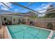 A refreshing screened-in pool is surrounded by brick and offers a relaxing outdoor space at 10442 Cirimoya Ln, Seminole, FL 33772