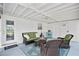Comfortable screened porch with wicker seating and access to the laundry room at 10442 Cirimoya Ln, Seminole, FL 33772
