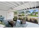 Relaxing screened porch with wicker seating and a pleasant outdoor view at 10442 Cirimoya Ln, Seminole, FL 33772