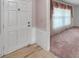 View of the home's entryway, featuring a classic white door and trim with neutral tile flooring at 111 W Anglewood Dr, Brandon, FL 33511
