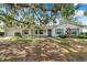 Charming single-story home featuring a brick facade and beautifully landscaped front yard with mature trees at 111 W Anglewood Dr, Brandon, FL 33511