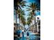 Street view of a tropical city with palm trees and people walking at 1120 N Shore Ne Dr # 201, St Petersburg, FL 33701