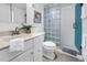 Well-lit bathroom featuring a glass block shower, a classic sink, and neutral decor at 1120 N Shore Ne Dr # 201, St Petersburg, FL 33701