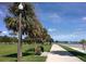 Scenic view of beach walkway lined with palm trees, park benches, and lighting at 1120 N Shore Ne Dr # 201, St Petersburg, FL 33701