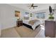 Bright bedroom showcasing a cozy bed, neutral decor, and natural light through large windows at 1120 N Shore Ne Dr # 201, St Petersburg, FL 33701