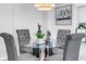 Bright dining area with a glass table, tufted chairs, and modern decor at 1120 N Shore Ne Dr # 201, St Petersburg, FL 33701