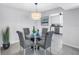 Chic dining area with a round glass table, upholstered chairs, and modern lighting at 1120 N Shore Ne Dr # 201, St Petersburg, FL 33701