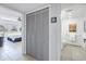 Hallway view into bedroom and bathroom, featuring tiled floors, closet, and a bed with view to the outside at 1120 N Shore Ne Dr # 201, St Petersburg, FL 33701