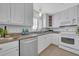 Bright kitchen with a stainless steel dishwasher and a view from the large window at 1120 North Shore Ne Dr # 201, St Petersburg, FL 33701
