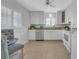 Bright kitchen features white cabinets, tile floor, and stainless-steel dishwasher at 1120 N Shore Ne Dr # 201, St Petersburg, FL 33701