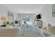 Bright and airy living room with balcony access, light-colored furniture, and a modern rug at 1120 N Shore Ne Dr # 201, St Petersburg, FL 33701