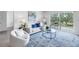 Bright living room with stylish furniture, area rug and sliding glass doors to a balcony at 1120 N Shore Ne Dr # 201, St Petersburg, FL 33701