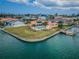 Stunning waterfront home featuring a private pool, dock, and lush landscaping at 11625 5Th E St, Treasure Island, FL 33706