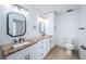 Tastefully designed bathroom with double sinks, granite counters and ample storage space at 11625 5Th E St, Treasure Island, FL 33706