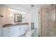 Contemporary bathroom with granite counters, a glass shower and bronze fixtures at 11625 5Th E St, Treasure Island, FL 33706