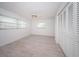 Bright bedroom featuring a ceiling fan, neutral tile floors, and a closet with shuttered doors at 11625 5Th E St, Treasure Island, FL 33706