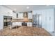 Kitchen with stainless appliances and expansive granite countertop island at 11625 5Th E St, Treasure Island, FL 33706