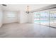 Living room with water views, chandelier and sliding glass door access to the pool at 11625 5Th E St, Treasure Island, FL 33706