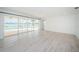 Open living room with tile floors and sliding glass doors offering waterfront views at 11625 5Th E St, Treasure Island, FL 33706