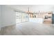 Open floor plan living room area leading into a kitchen with stainless appliances at 11625 5Th E St, Treasure Island, FL 33706