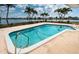 Backyard swimming pool surrounded by palm trees and a waterfront view at 11625 5Th E St, Treasure Island, FL 33706