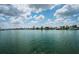 Beautiful waterfront view overlooking calm water with lush palm trees lining residential canal community homes at 11625 5Th E St, Treasure Island, FL 33706