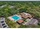 Aerial view of community pool, clubhouse, and manicured landscaping showcasing the community's amenities at 11807 Raintree Lake Ln # B, Tampa, FL 33617