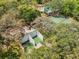 Aerial view of tennis and racquetball courts, along with a community pool, all surrounded by mature trees at 11807 Raintree Lake Ln # B, Tampa, FL 33617