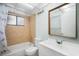 A classic bathroom with warm tile accents, modern fixtures, and a combined shower and tub at 11807 Raintree Lake Ln # B, Tampa, FL 33617