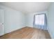 A clean and bright bedroom featuring light blue walls, light wood floors, and ample natural light at 11807 Raintree Lake Ln # B, Tampa, FL 33617