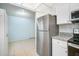 Efficient kitchen layout with stainless steel refrigerator and ample counter space at 11807 Raintree Lake Ln # B, Tampa, FL 33617