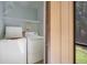 Bright laundry room featuring full size side by side washer and dryer, with built in shelving above at 11807 Raintree Lake Ln # B, Tampa, FL 33617