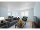 Comfortable living room with a couch, chairs, coffee table, and dining set at 11807 Raintree Lake Ln # B, Tampa, FL 33617