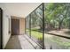 Spacious screened-in patio overlooking a scenic green area, great for relaxation and enjoying the outdoors at 11807 Raintree Lake Ln # B, Tampa, FL 33617