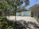 Fenced in tennis court, ready for a match, surrounded by trees and green space at 11807 Raintree Lake Ln # B, Tampa, FL 33617