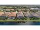 An aerial view of the property backing on a lake and screened pool area at 13208 Malachite Dr, Bradenton, FL 34211