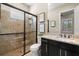 Bathroom featuring glass enclosed shower with a dark vanity cabinet and granite countertop at 13208 Malachite Dr, Bradenton, FL 34211
