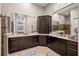 Bathroom featuring dual sinks with marble countertops, espresso cabinets, and a large framed mirror at 13208 Malachite Dr, Bradenton, FL 34211