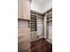 Walk-in closet with built-in wooden shelving and drawers, and hardwood flooring at 13208 Malachite Dr, Bradenton, FL 34211