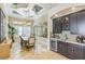 Dining area with a bar featuring decorative lighting, bar refrigerator, and dark cabinetry at 13208 Malachite Dr, Bradenton, FL 34211