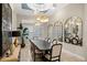 Elegant dining room features decorative lighting, large windows, and stylish wall mirrors at 13208 Malachite Dr, Bradenton, FL 34211